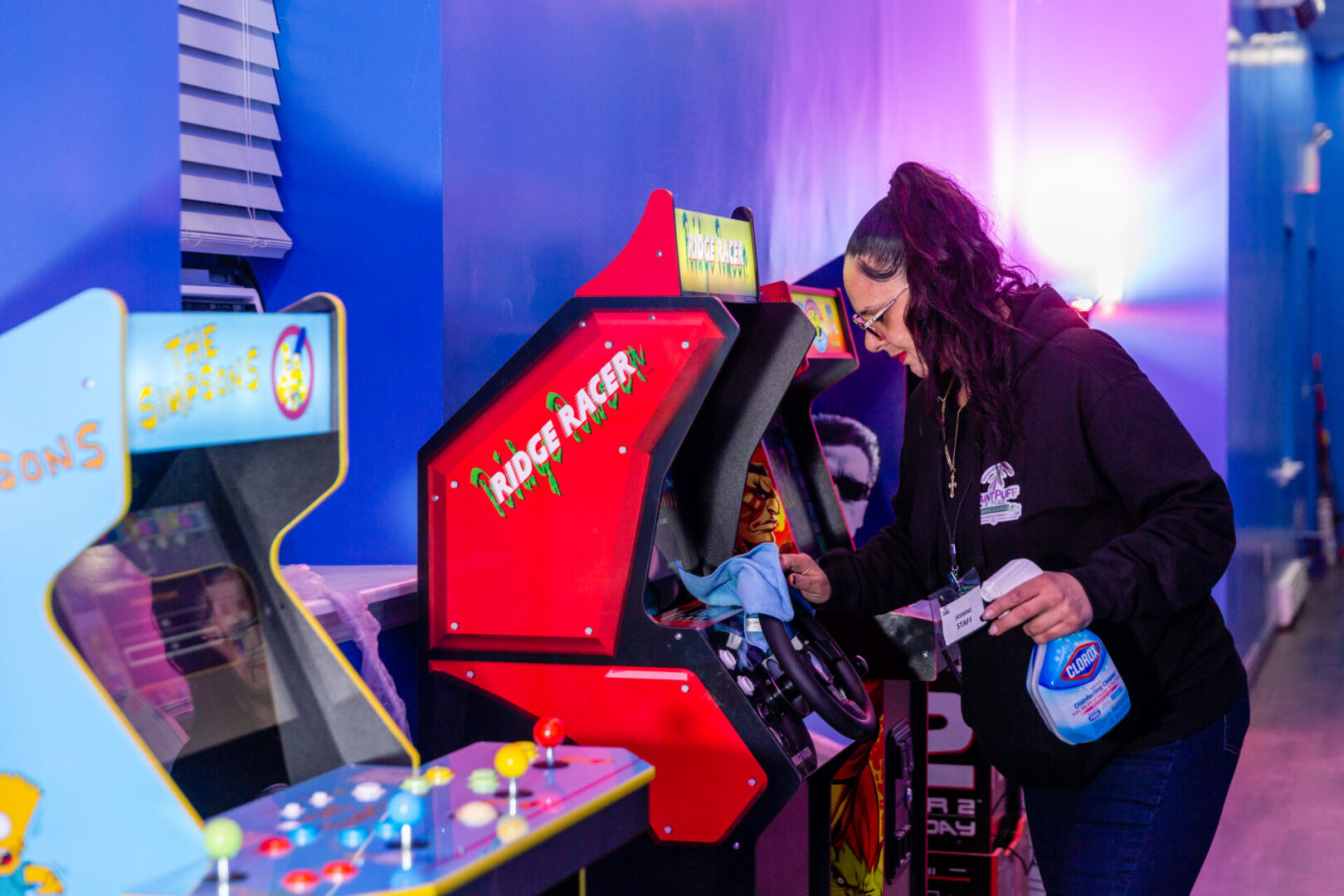 a woman cleaning a gaming machine